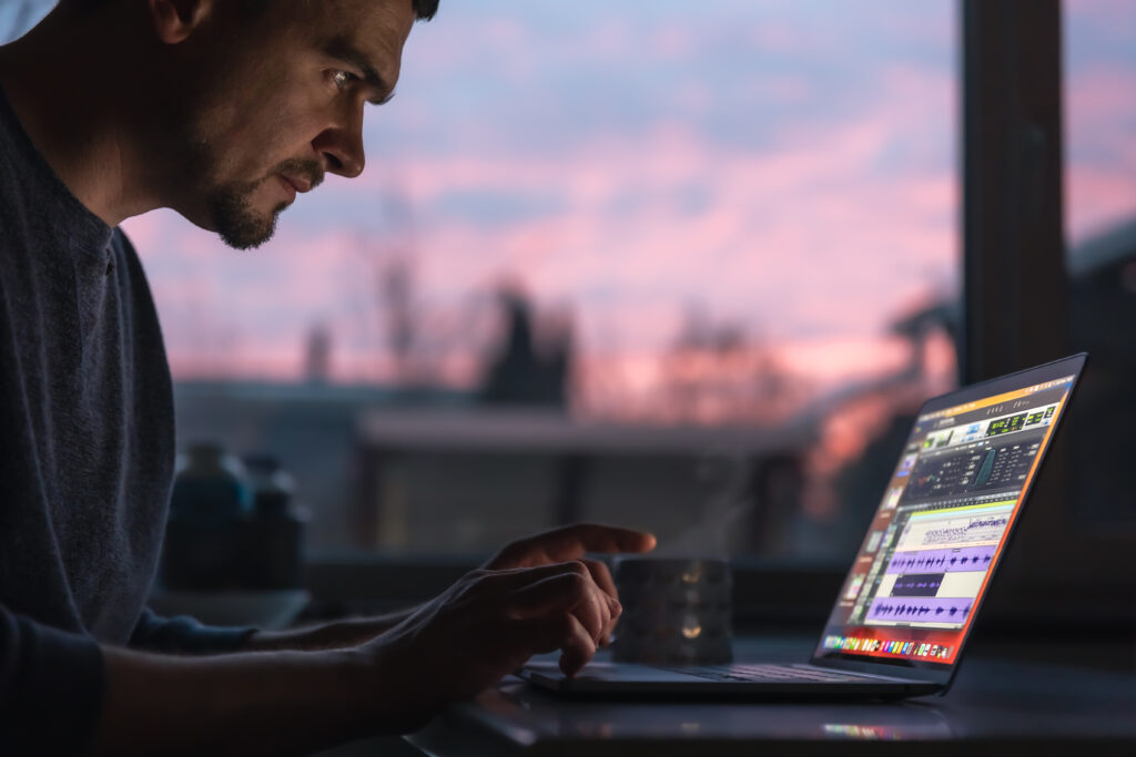 man works with sound laptop early morning